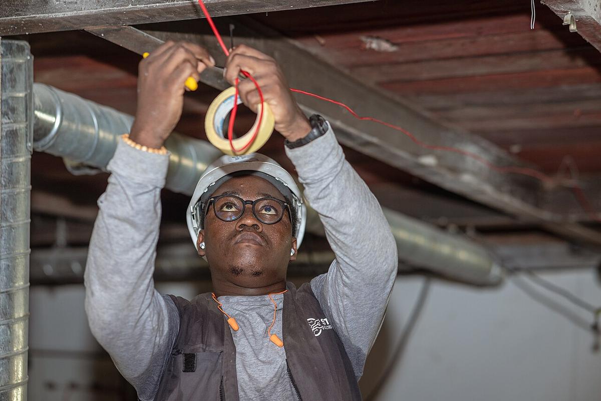 Electrician pulling cable at work